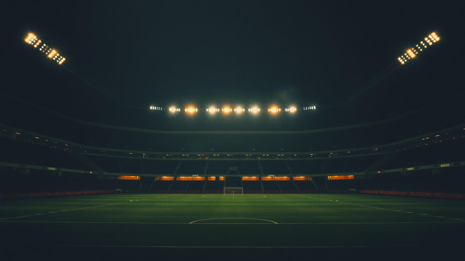 Floodlit football stadium at night